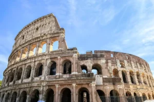 Exterior architectural arches of the historic Colosseum in Rome under a bright sky